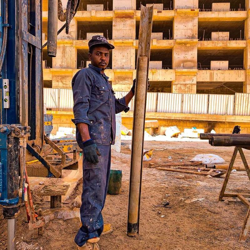 Technician holding a recovered soil core sample