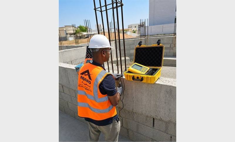Abaad technician performing a concrete resistivity test on a column