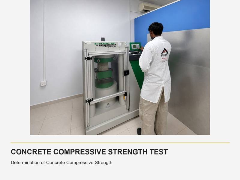 Abaad technician operating a compressive strength testing machine on a concrete sample