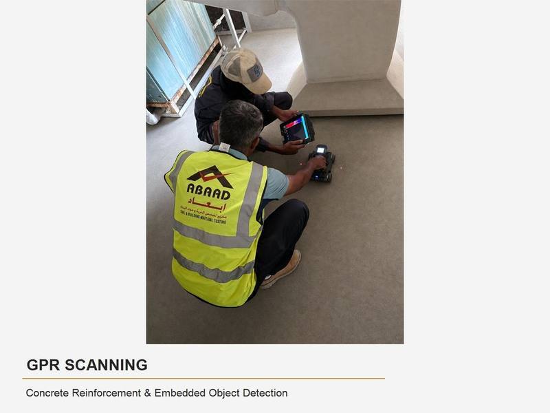 Abaad technicians performing a GPR scanning survey with a tablet reader on a concrete slab